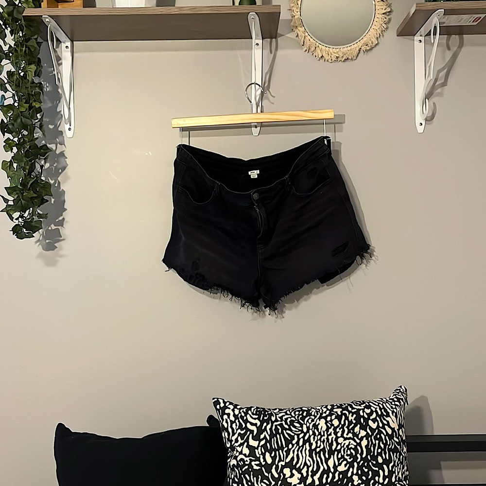 Distressed black jean shorts. Elastic waistband on the back for extra comfort.